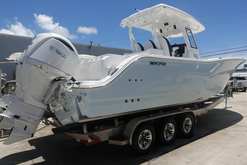  Yacht Photos Pics 2025 Sea Fox 328 Commander boat on trailer, featuring twin engines and sleek design.