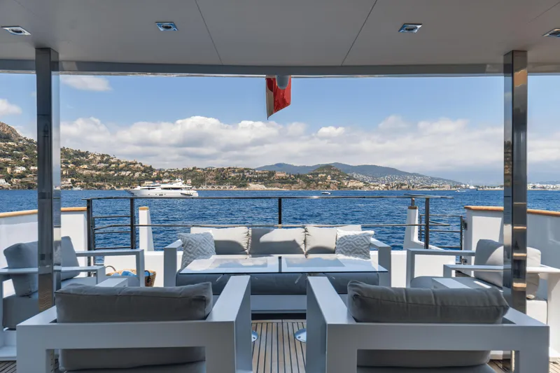 Eva Yacht Photos Pics Luxurious deck view from 1992 Cheoy Lee Custom yacht, overlooking serene blue waters and coastal landscape.