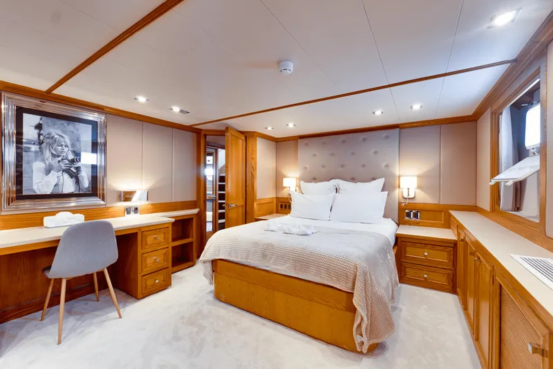 Eva Yacht Photos Pics Luxurious bedroom on a 1992 Cheoy Lee Custom yacht with elegant wood furnishings.