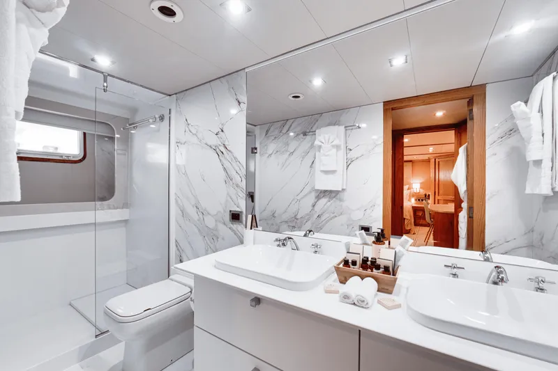Eva Yacht Photos Pics Luxurious bathroom on a 1992 Cheoy Lee Custom yacht with marble walls and dual sinks.