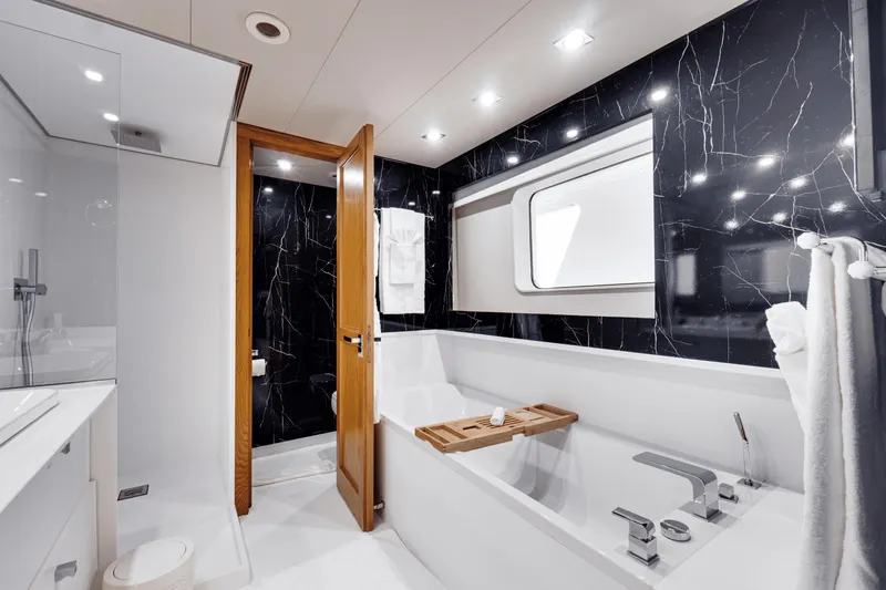 Eva Yacht Photos Pics Luxurious bathroom on 1992 Cheoy Lee Custom yacht with modern fixtures and marble accents.