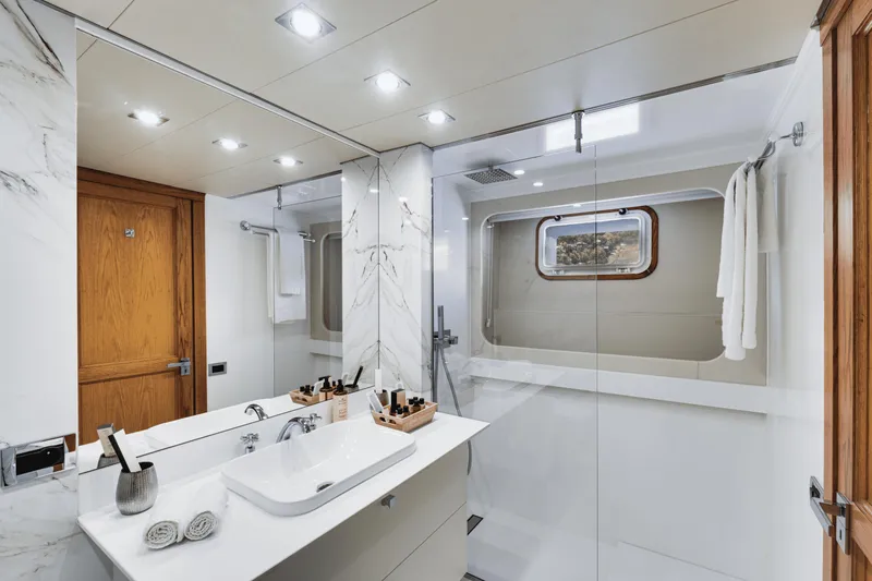 Eva Yacht Photos Pics Luxurious bathroom in a 1992 Cheoy Lee Custom yacht with modern fixtures and wooden accents.