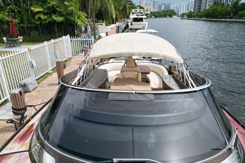  Yacht Photos Pics Luxury 2005 Riva RivaRama 44 yacht docked by a scenic waterfront.