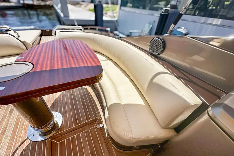  Yacht Photos Pics Luxurious 2005 Riva RivaRama 44 yacht interior with elegant wood table and cream seating.