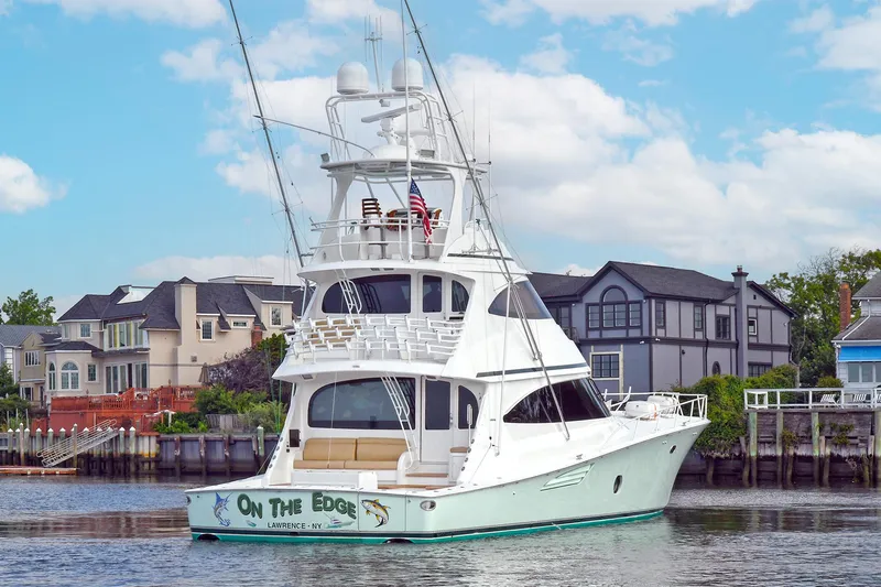 On The Edge Yacht Photos Pics 2018 Viking 80 Enclosed Skybridge yacht docked near waterfront homes.