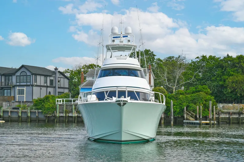 On The Edge Yacht Photos Pics 2018 Viking 80 Enclosed Skybridge yacht docked near waterfront homes.