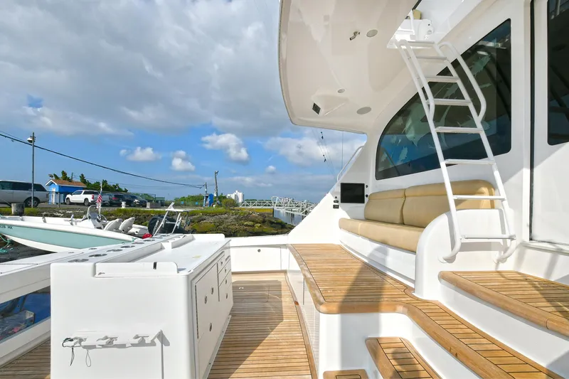 On The Edge Yacht Photos Pics Luxurious 2018 Viking 80 Enclosed Skybridge yacht with teak deck and seating area.