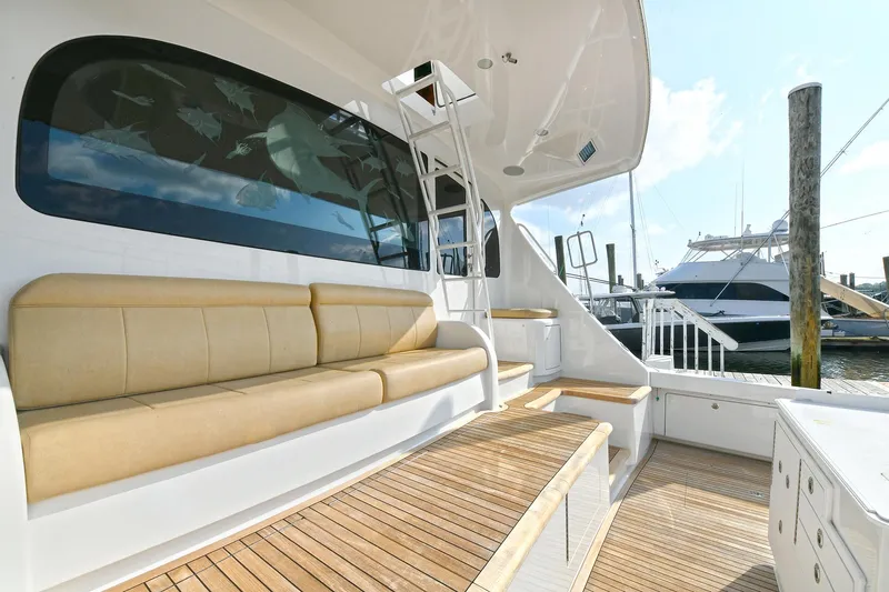 On The Edge Yacht Photos Pics 2018 Viking 80 Enclosed Skybridge yacht with teak deck and beige seating.
