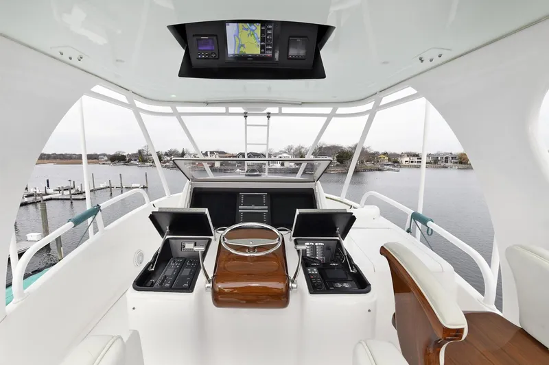 On The Edge Yacht Photos Pics 2018 Viking 80 Enclosed Skybridge yacht helm with advanced navigation systems and panoramic water views.