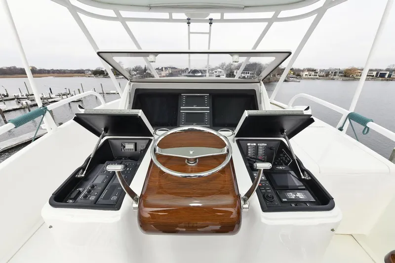 On The Edge Yacht Photos Pics Cockpit of 2018 Viking 80 Enclosed Skybridge yacht with advanced navigation controls.