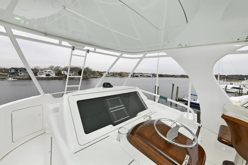 On The Edge Yacht Photos Pics 2018 Viking 80 Enclosed Skybridge yacht helm with modern navigation system.