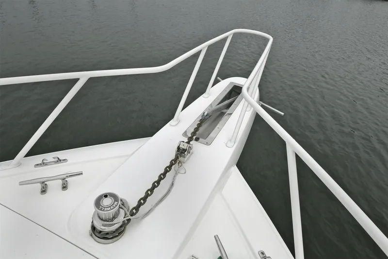 On The Edge Yacht Photos Pics Bow of 2018 Viking 80 Enclosed Skybridge yacht with anchor chain and railing.