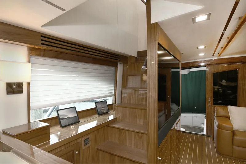 On The Edge Yacht Photos Pics Luxurious interior of 2018 Viking 80 Enclosed Skybridge yacht with wooden finishes and modern design.