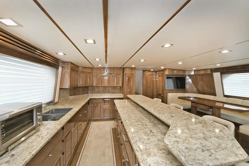 On The Edge Yacht Photos Pics Luxurious interior of 2018 Viking 80 Enclosed Skybridge yacht with modern kitchen and dining area.