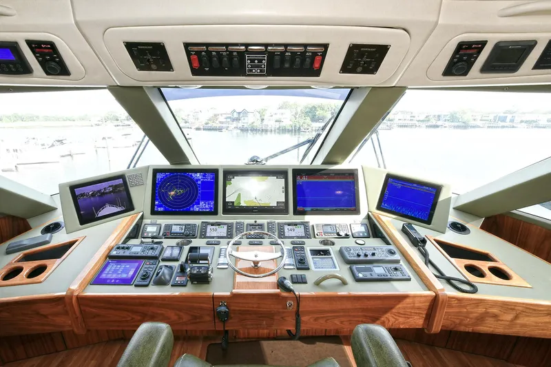 On The Edge Yacht Photos Pics Cockpit of 2018 Viking 80 Enclosed Skybridge with advanced navigation systems and controls.
