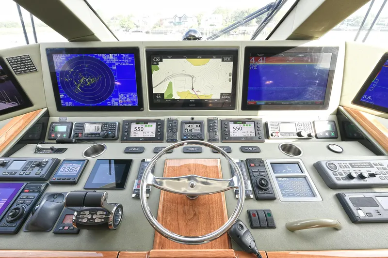 On The Edge Yacht Photos Pics Control panel of 2018 Viking 80 Enclosed Skybridge with advanced navigation displays and controls.