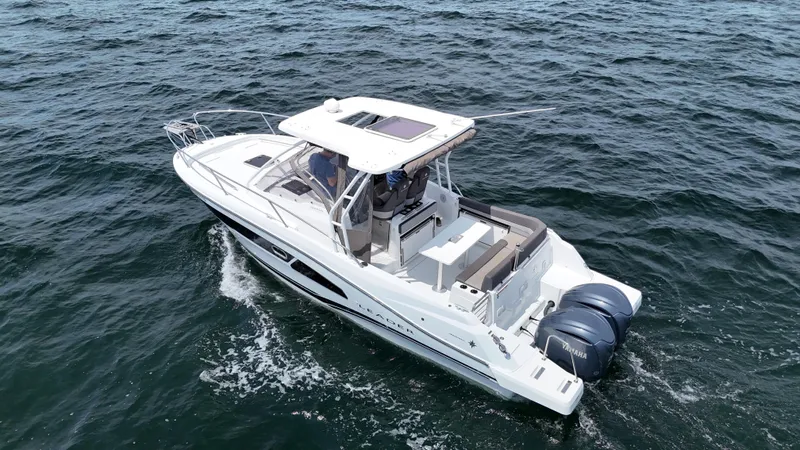  Yacht Photos Pics 2022 Jeanneau Leader 9.0 WA cruising on open water, featuring twin engines and sleek design.