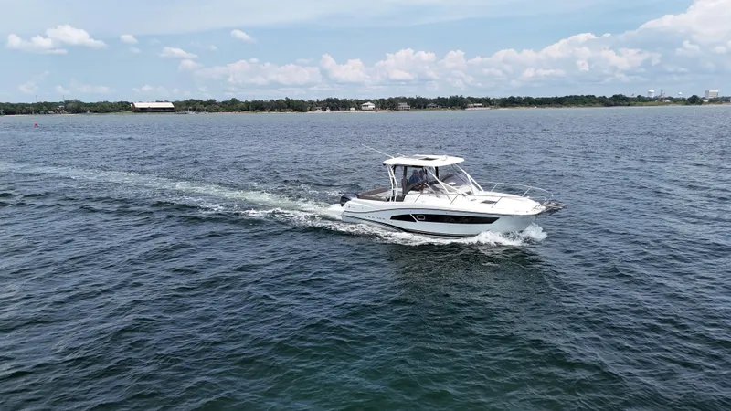  Yacht Photos Pics 2022 Jeanneau Leader 9.0 WA cruising on open water under a clear sky.