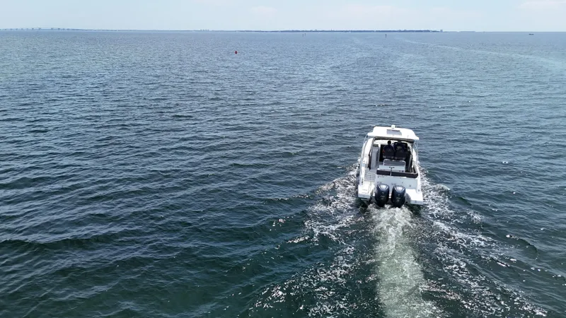  Yacht Photos Pics 2022 Jeanneau Leader 9.0 WA cruising on open water, rear view.