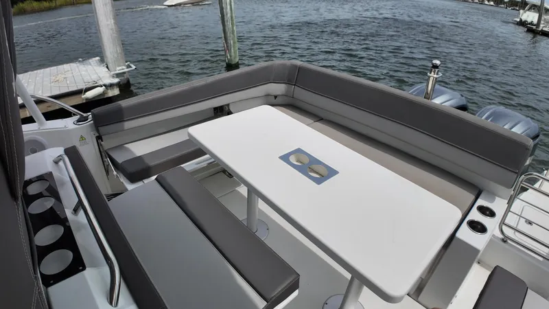  Yacht Photos Pics 2022 Jeanneau Leader 9.0 WA boat with spacious seating and table on deck.