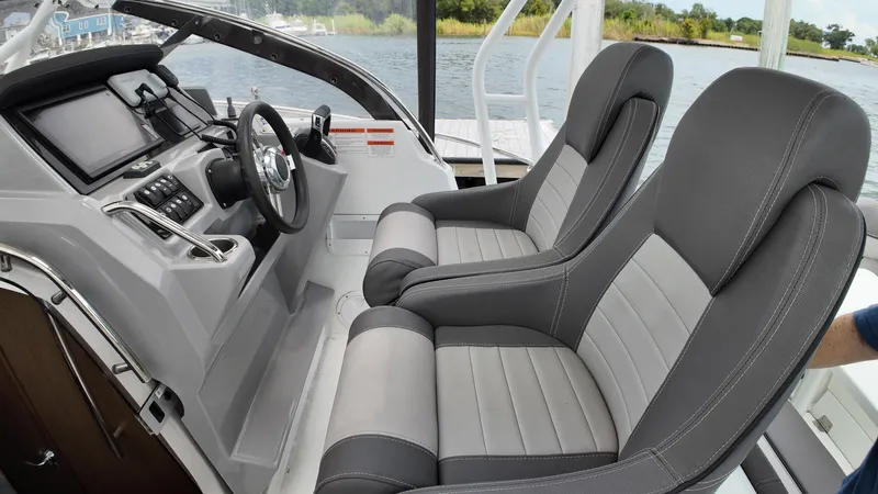  Yacht Photos Pics 2022 Jeanneau Leader 9.0 WA cockpit with dual gray seats and modern dashboard.