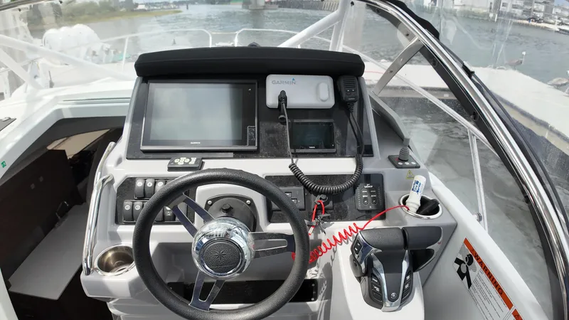  Yacht Photos Pics 2022 Jeanneau Leader 9.0 WA helm with modern navigation equipment and steering wheel.