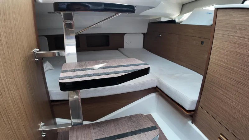  Yacht Photos Pics 2022 Jeanneau Leader 9.0 WA cabin interior with wooden steps and modern design.