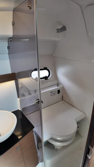  Yacht Photos Pics 2022 Jeanneau Leader 9.0 WA bathroom with modern fixtures and compact design.