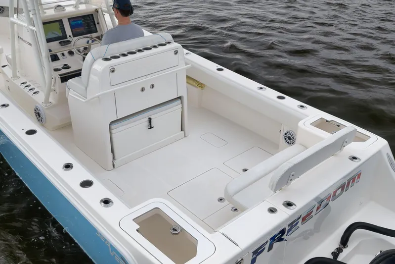  Yacht Photos Pics 2023 SeaVee 322Z boat interior with helm, seating, and storage, on water.