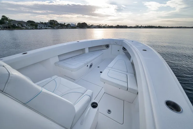  Yacht Photos Pics 2023 SeaVee 322Z boat interior with white seating, on calm water at sunset.