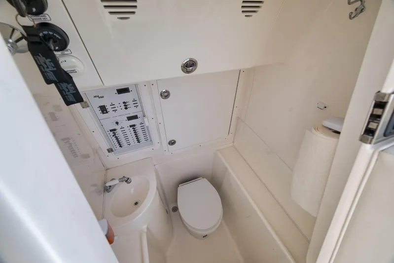  Yacht Photos Pics 2023 SeaVee 322Z boat interior with toilet, sink, and control panel.