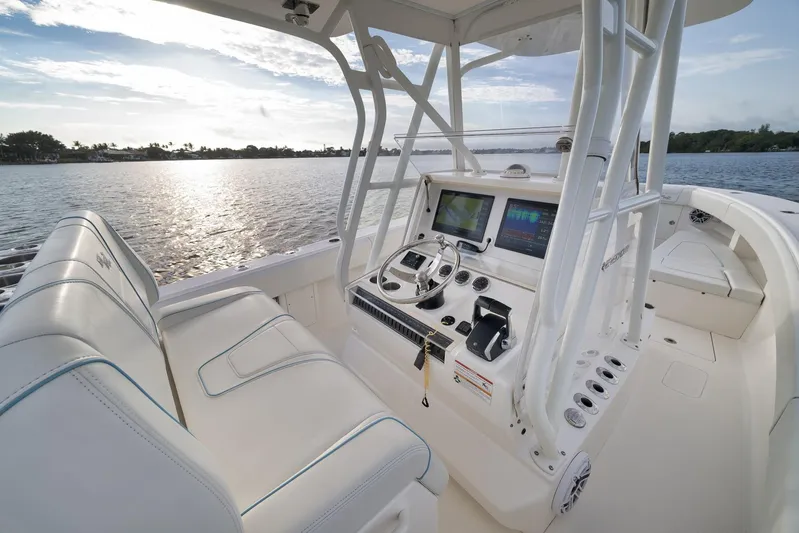  Yacht Photos Pics 2023 SeaVee 322Z boat cockpit with modern controls and seating, overlooking serene water.