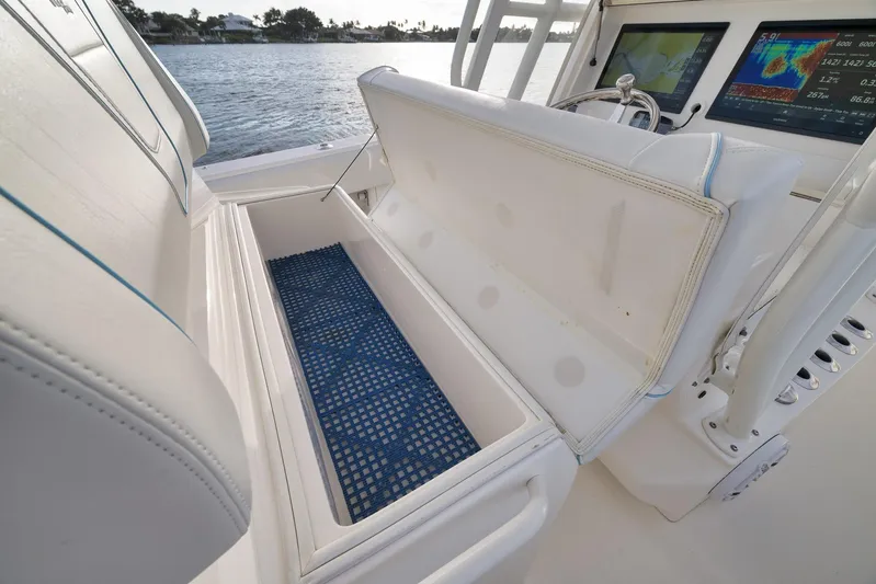  Yacht Photos Pics 2023 SeaVee 322Z boat interior with open storage compartment and navigation screens.