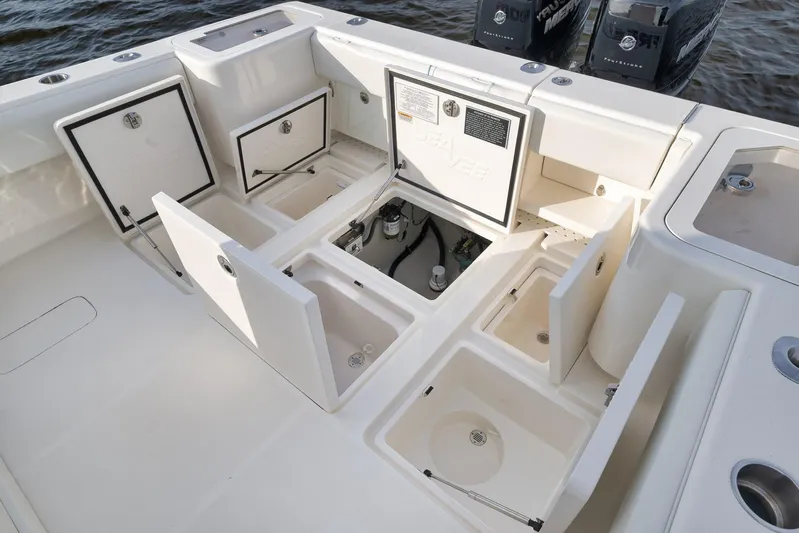  Yacht Photos Pics 2023 SeaVee 322Z boat deck with open storage compartments and dual engines.