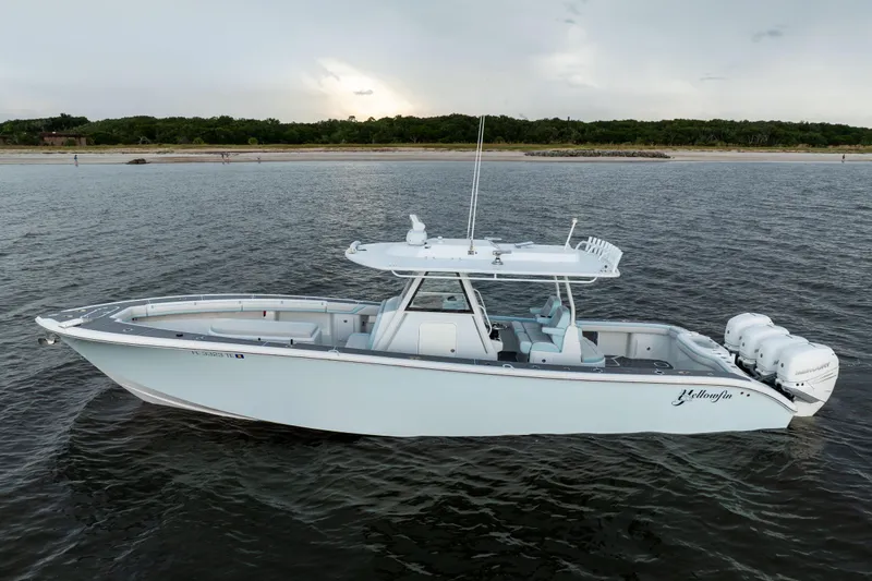  Yacht Photos Pics 2018 Yellowfin 39 Offshore boat on calm water near a sandy shoreline.