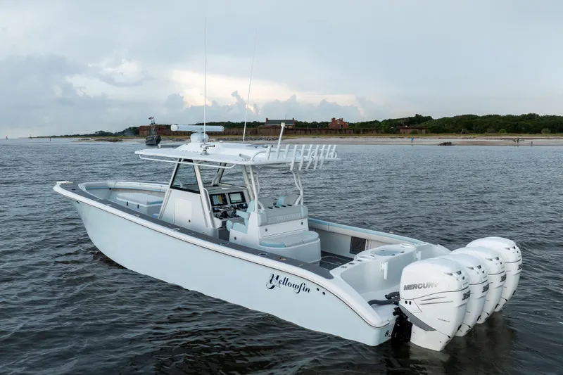  Yacht Photos Pics 2018 Yellowfin 39 Offshore boat with four Mercury engines on calm water near shore.