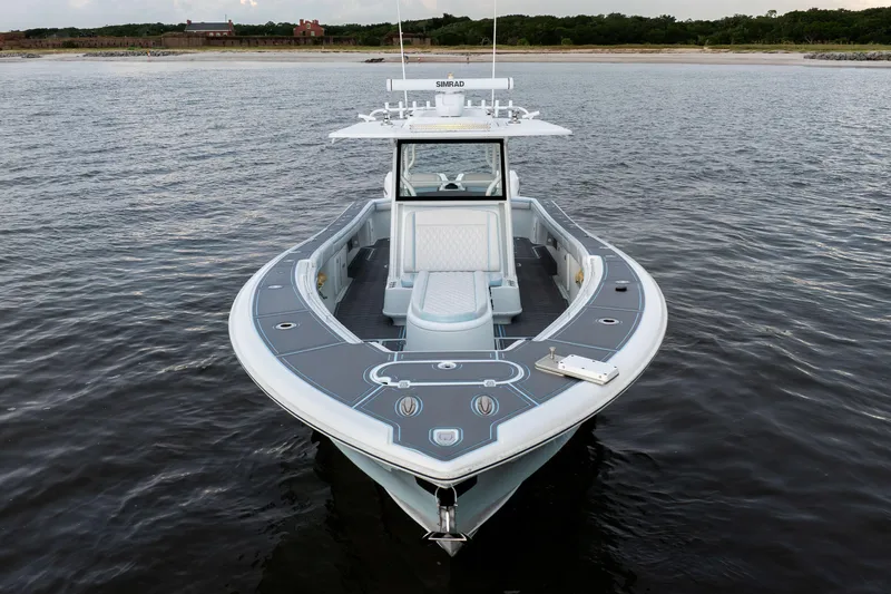  Yacht Photos Pics 2018 Yellowfin 39 Offshore boat on calm water near a sandy shore.