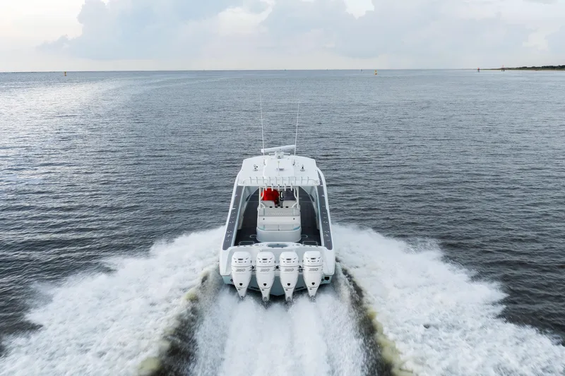  Yacht Photos Pics 2018 Yellowfin 39 Offshore boat cruising on open water, rear view.