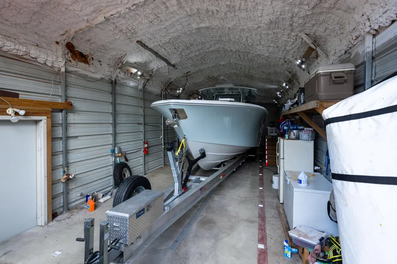  Yacht Photos Pics 2018 Yellowfin 39 Offshore boat stored in a spacious garage with equipment.