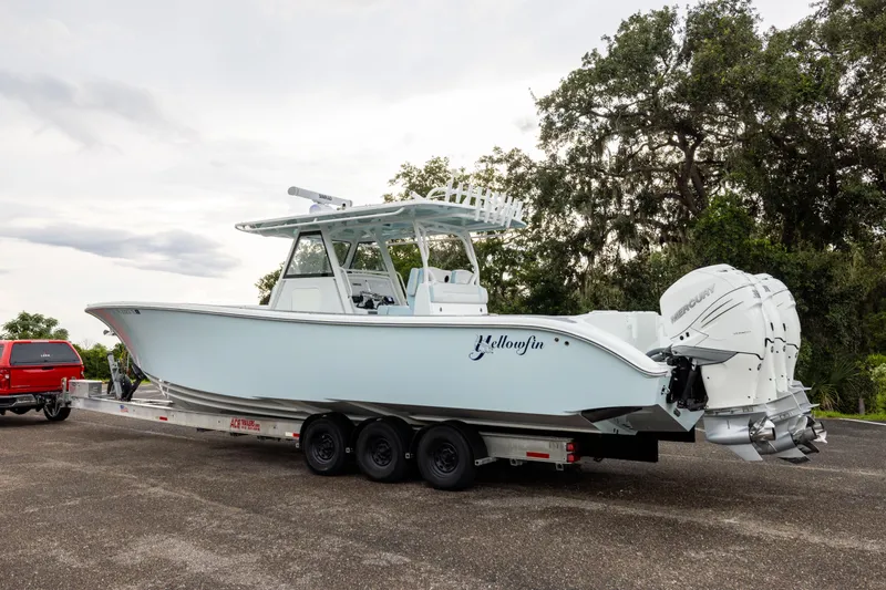 Yacht Photos Pics 2018 Yellowfin 39 Offshore boat on trailer, parked outdoors with trees in background.