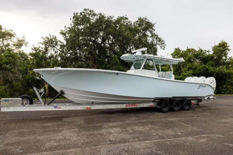  Yacht Photos Pics 2018 Yellowfin 39 Offshore boat on trailer, parked outdoors with trees in background.
