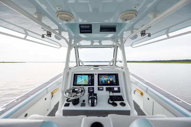  Yacht Photos Pics 2018 Yellowfin 39 Offshore boat cockpit with advanced navigation system and serene water view.