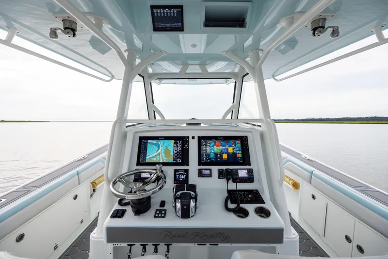  Yacht Photos Pics 2018 Yellowfin 39 Offshore boat cockpit with advanced navigation systems and steering wheel.