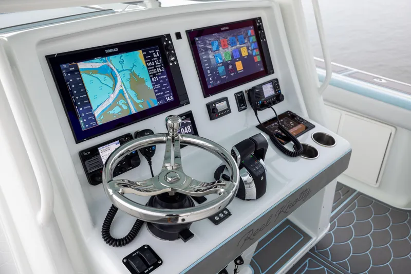  Yacht Photos Pics 2018 Yellowfin 39 Offshore boat dashboard with navigation screens and steering wheel.
