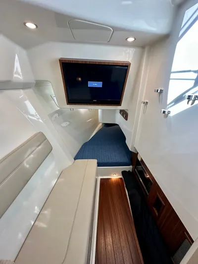 Breeezy Yacht Photos Pics Interior of 2020 Pursuit DC 365 Dual Console with TV and seating area.