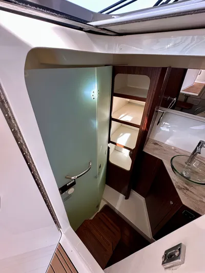 Breeezy Yacht Photos Pics Interior of 2020 Pursuit DC 365 Dual Console with bathroom and sink.