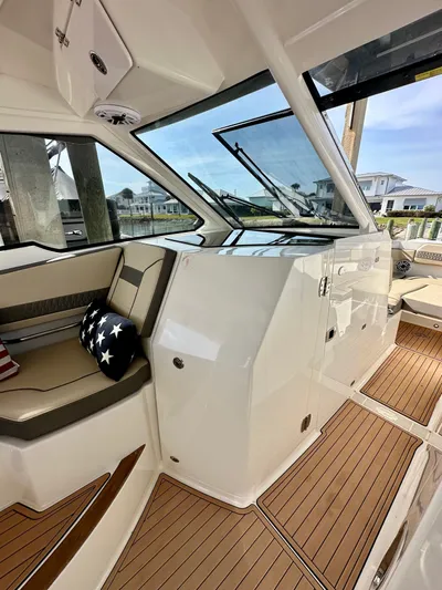 Breeezy Yacht Photos Pics Interior of 2020 Pursuit DC 365 Dual Console with wood flooring.