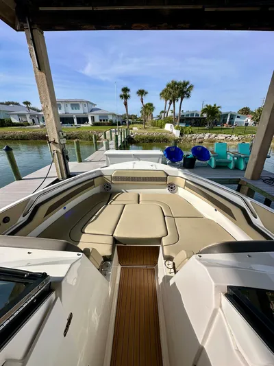 Breeezy Yacht Photos Pics 2020 Pursuit DC 365 Dual Console boat at dock with palm trees in background.