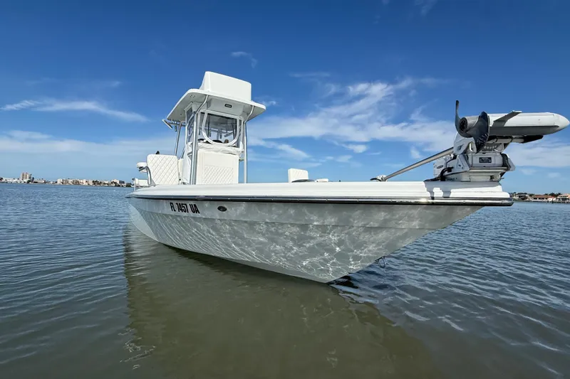  Yacht Photos Pics 2024 East Cape 25 Hybrid boat on calm water under clear blue sky.