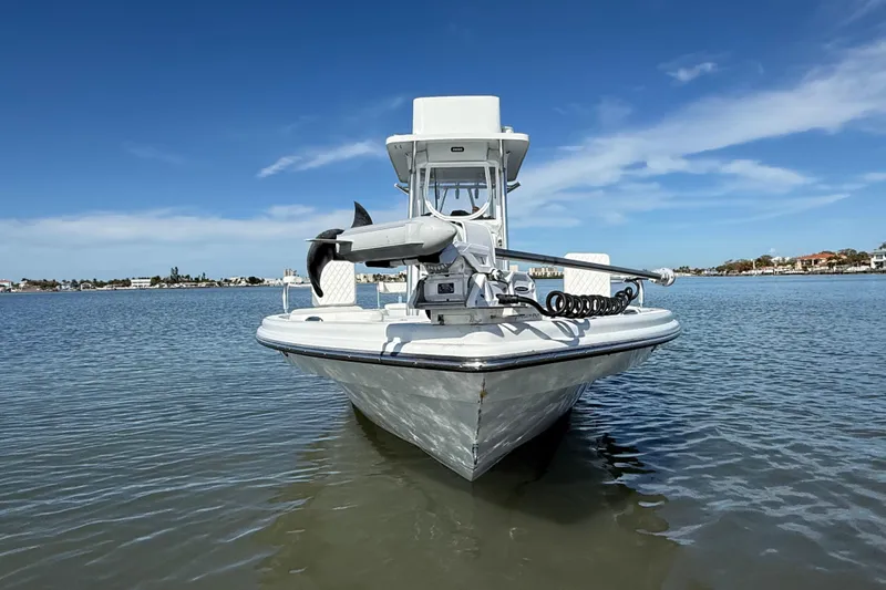  Yacht Photos Pics 2024 East Cape 25 Hybrid boat on calm water under clear blue sky.
